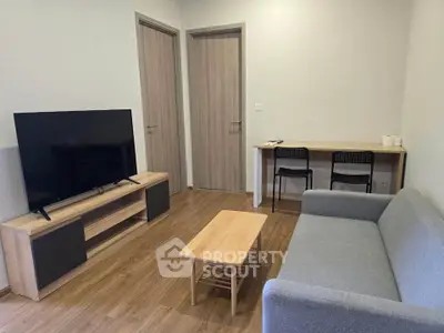 Modern living room with sleek furniture and flat-screen TV, perfect for relaxation and entertainment.