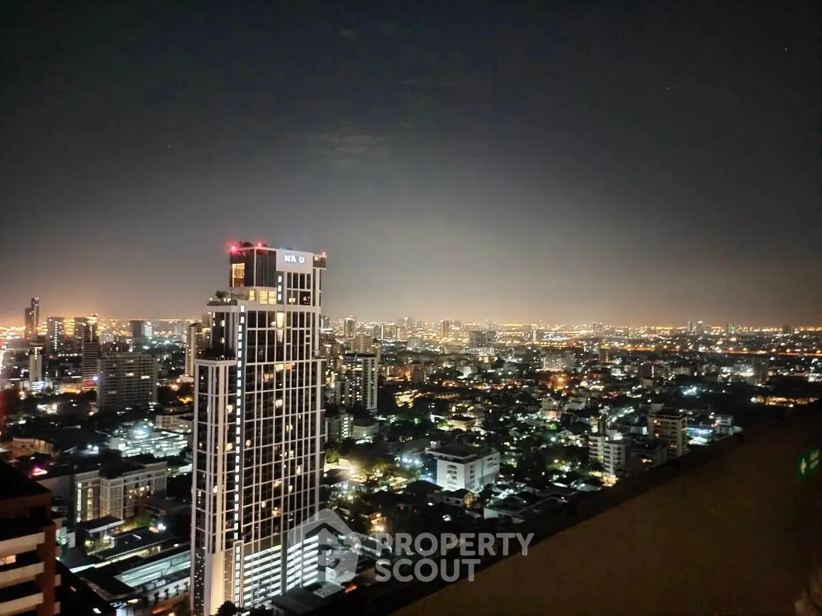 Stunning cityscape night view from high-rise building balcony
