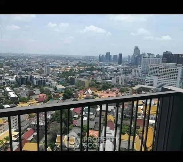 Stunning cityscape view from a high-rise balcony, showcasing urban skyline and vibrant neighborhood.
