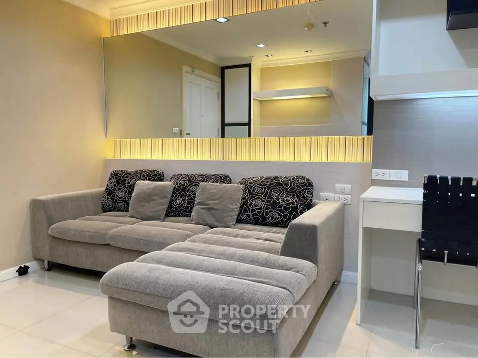 Modern living room with stylish sofa and elegant lighting, perfect for relaxation and entertaining.