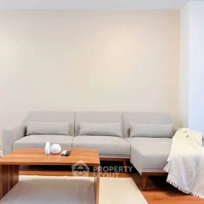 Modern living room with stylish gray sofa and wooden coffee table, perfect for cozy relaxation.