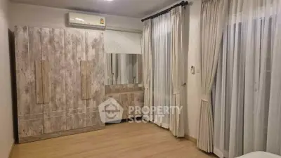 Spacious bedroom with modern wardrobe and elegant curtains