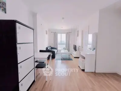 Spacious modern living room with sleek furniture and large windows offering a stunning view.