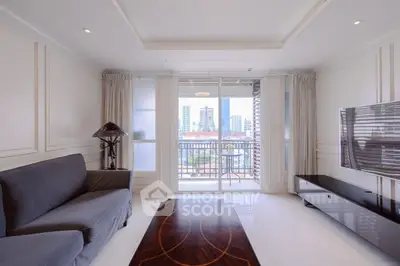 Spacious living room with modern decor and city view balcony.