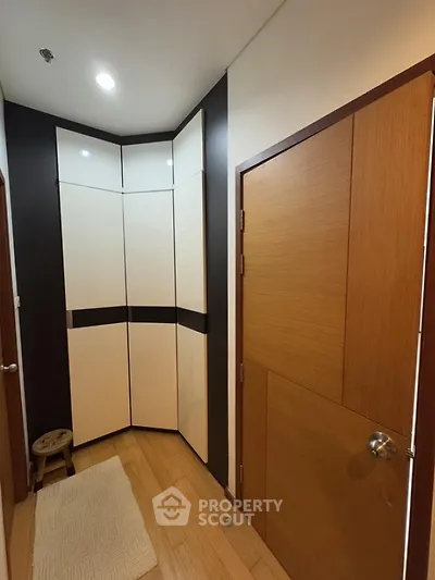 Modern hallway with sleek storage cabinets and wooden doors