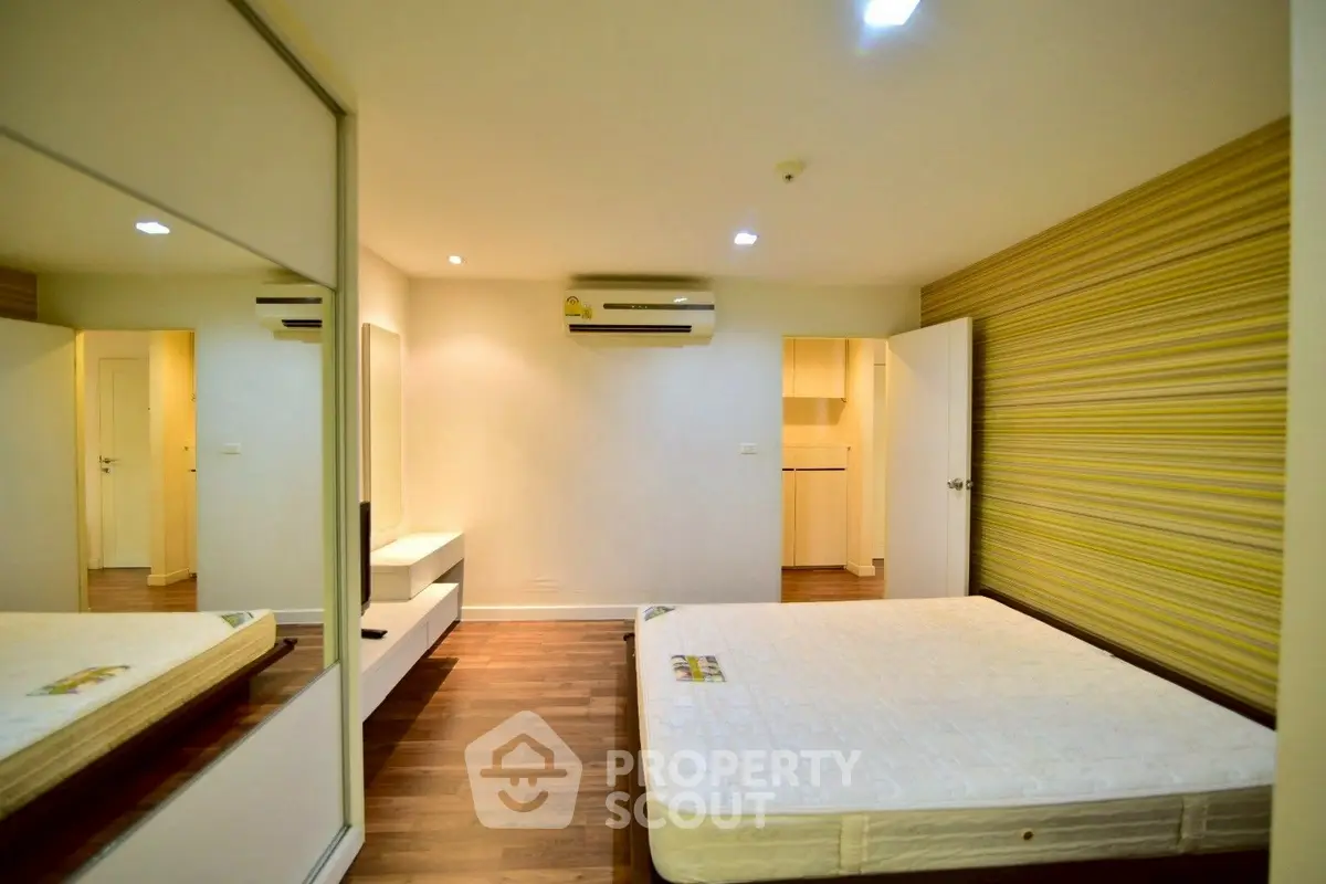 Spacious bedroom with modern design and ample natural light