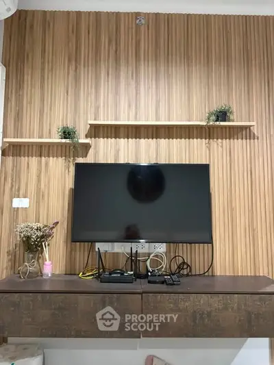 Modern living room with stylish wooden paneling and mounted TV