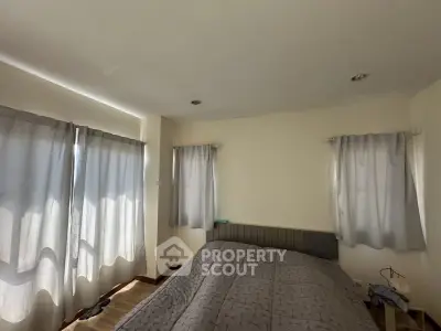 Cozy bedroom with soft lighting and modern decor, perfect for relaxation.