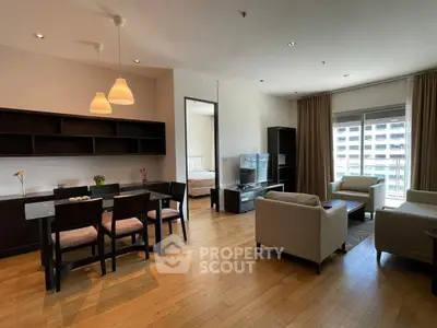 Spacious modern living room with dining area and natural light in urban apartment