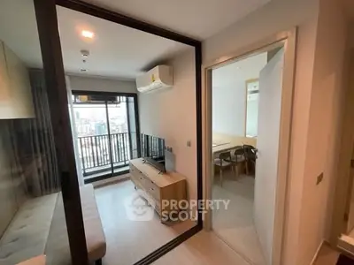 Modern apartment interior with balcony view and stylish furnishings.