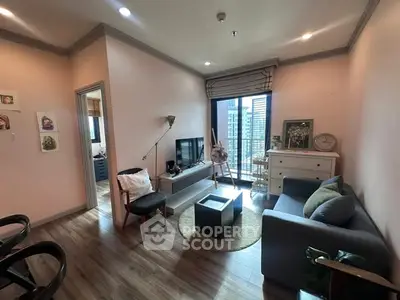 Charming living room with modern decor and city view balcony, perfect for urban living.