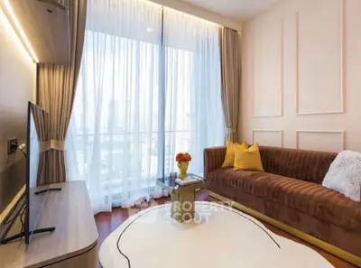 Elegant living room with modern decor, large window, and cozy sofa in a high-rise apartment.