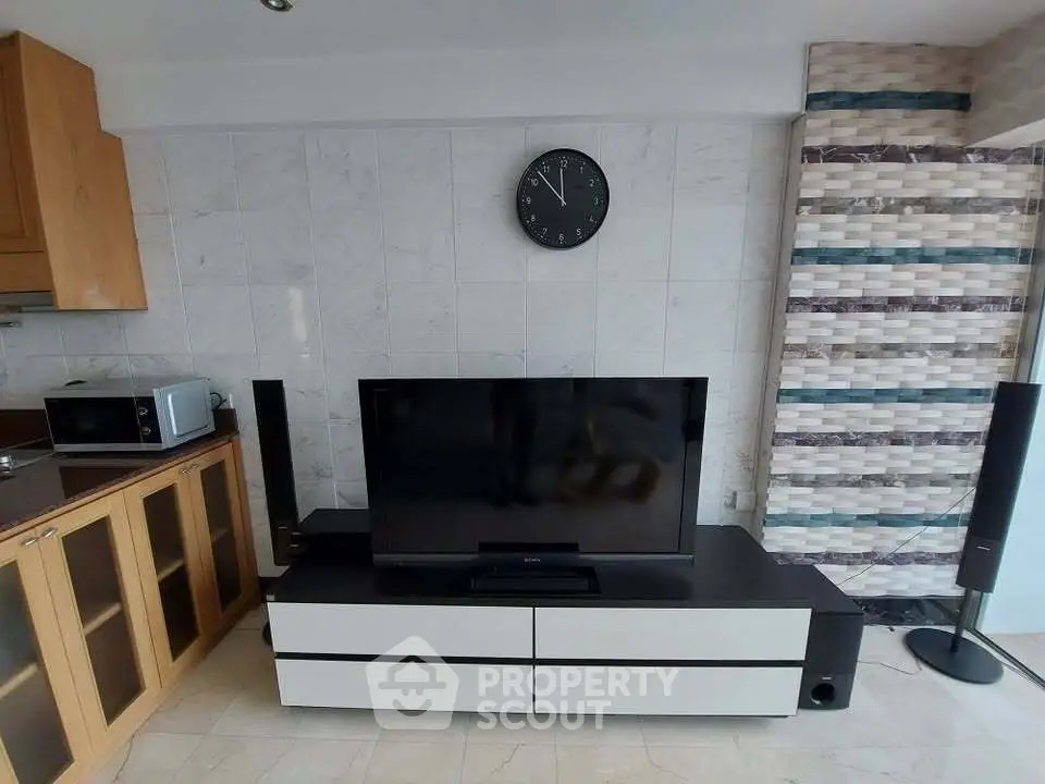 Modern living room with sleek TV setup and stylish cabinetry