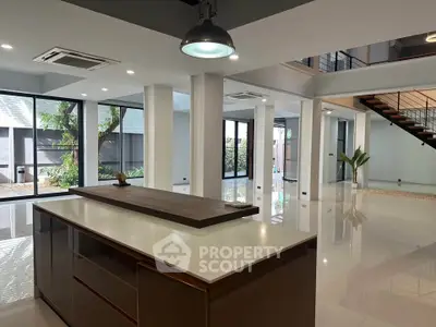 Spacious modern living area with open layout and stylish kitchen island, perfect for entertaining.