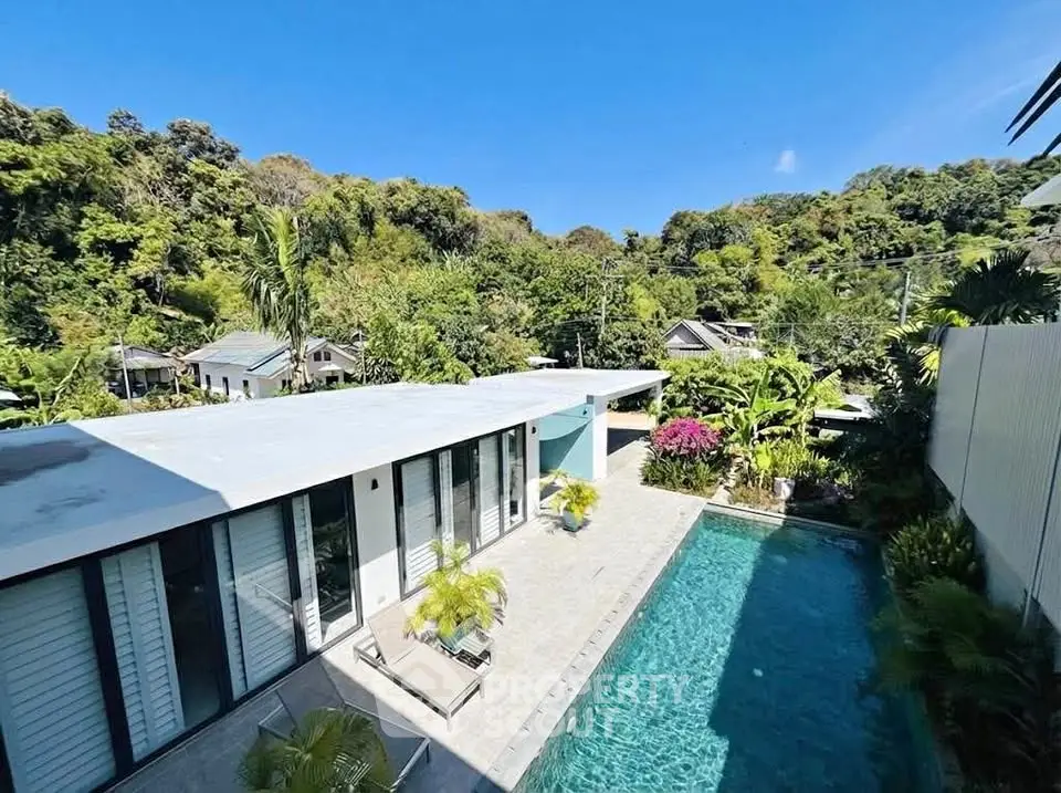 Luxurious modern villa with private pool and lush greenery view