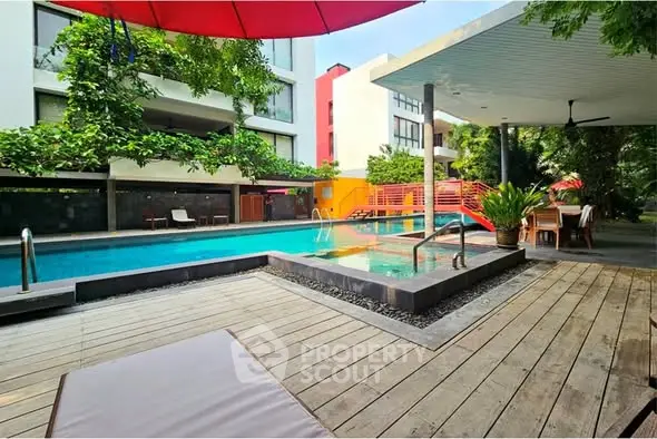 Luxurious poolside area with modern design and lush greenery