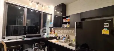 Modern kitchen with sleek black cabinets and city view window