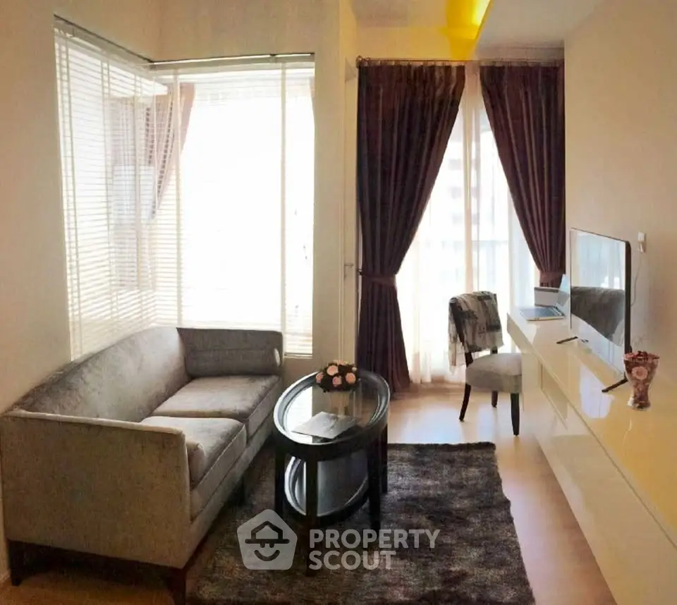 Cozy living room with modern decor and large windows for natural light.