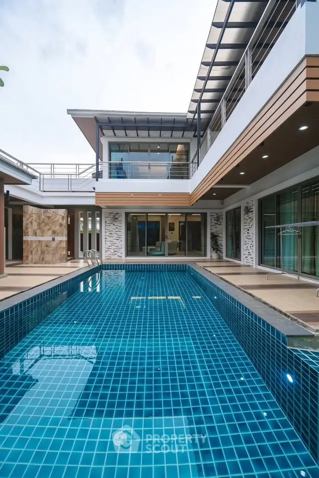 Luxurious modern home with stunning outdoor pool and sleek architectural design.