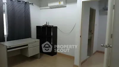 Spacious study room with desk and shelving, ideal for productivity.