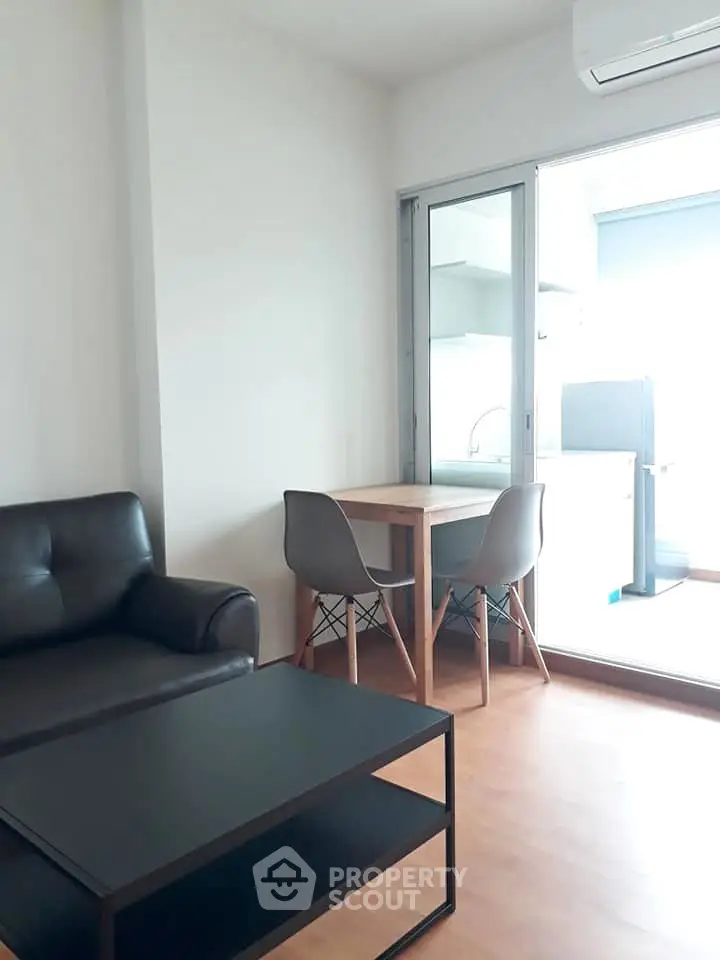 Modern living room with sleek furniture and open kitchen layout