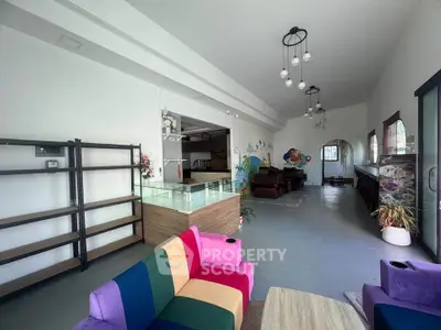 Spacious modern living room with colorful furniture and open layout, perfect for entertaining.