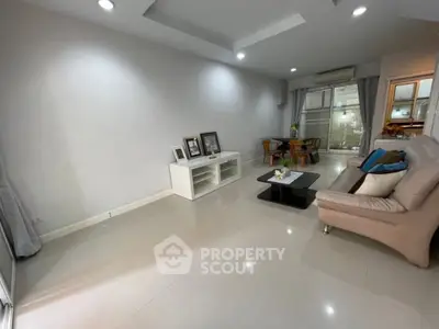Spacious modern living room with sleek furniture and elegant decor, perfect for relaxation and entertainment.