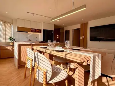 Modern open-plan kitchen and dining area with stylish decor and natural light.