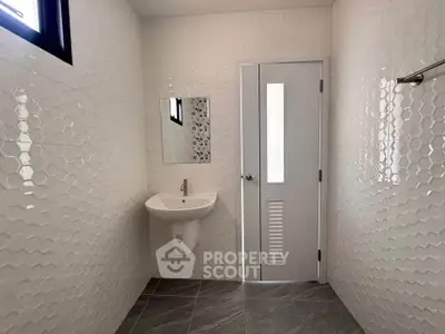 Modern bathroom with sleek white tiles and minimalist design