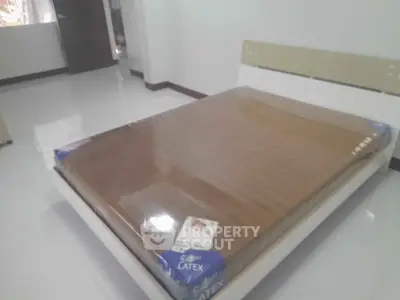 Spacious bedroom with new latex mattress on modern bed frame, perfect for comfort and relaxation.