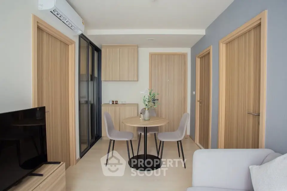 Modern living room with minimalist decor and wooden accents in a cozy apartment.