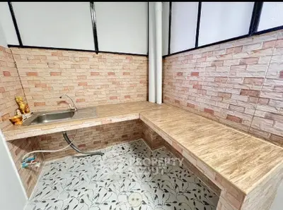 Charming kitchen with tiled walls and modern sink, perfect for culinary enthusiasts.