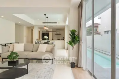 Spacious modern living room with pool view and elegant decor