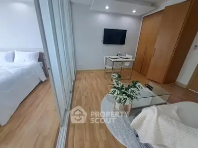 Modern studio apartment with wooden flooring and sleek furniture