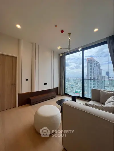 Modern living room with floor-to-ceiling windows offering stunning city views, elegant lighting, and contemporary furniture.