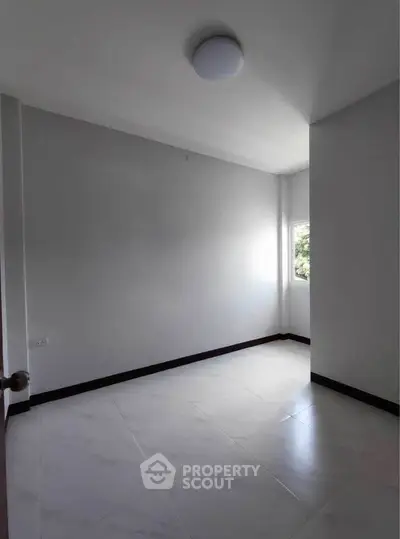 Spacious empty room with natural light and modern flooring