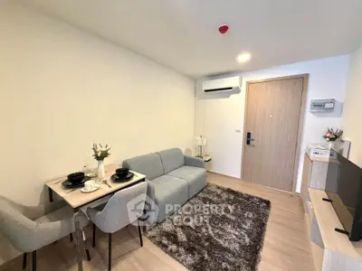 Modern living room with cozy sofa, dining area, and stylish decor in a contemporary apartment.
