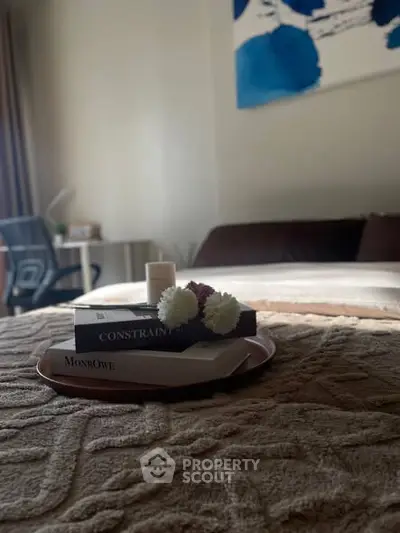 Cozy bedroom with stylish decor and natural light, perfect for relaxation and comfort.