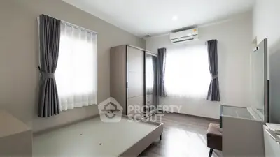 Spacious bedroom with modern furniture and natural light