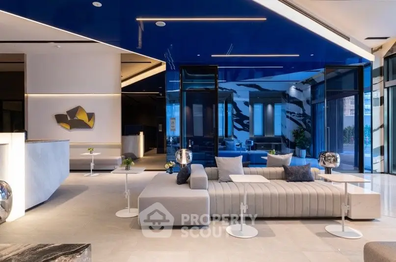 Luxurious modern living room with stylish furniture and blue accents in a contemporary setting.