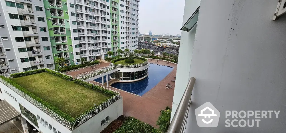 Modern apartment complex with pool and landscaped garden view