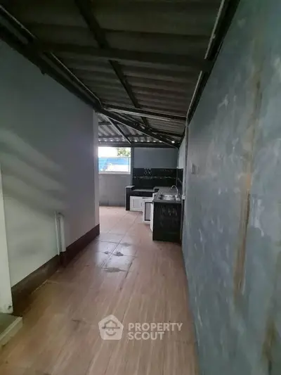 Spacious outdoor balcony with tiled flooring and partial roof cover, ideal for relaxation or entertainment.