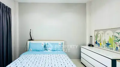 Modern bedroom with stylish decor and ample natural light