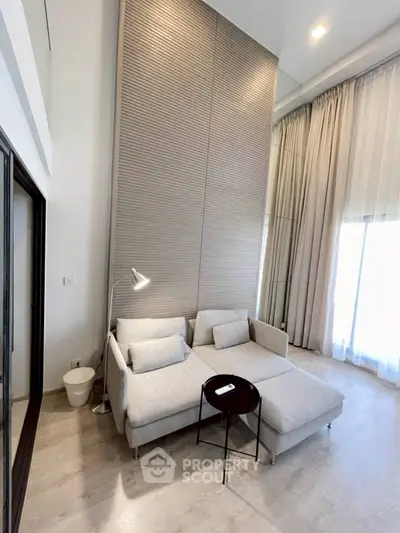 Modern living room with high ceiling and stylish furniture