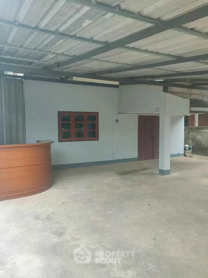 Spacious covered parking area with modern design and wooden accents.