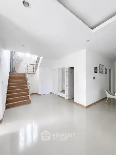 Spacious modern living room with staircase and elegant decor