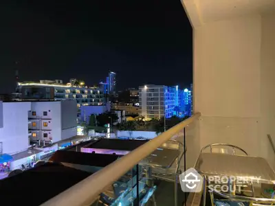 Stunning city view from modern balcony at night with vibrant lights