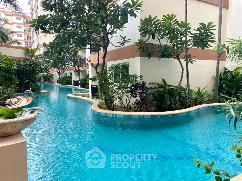 Luxurious residential pool surrounded by lush greenery and modern architecture.