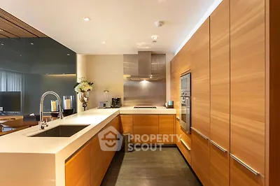 Modern kitchen with sleek wooden cabinetry and built-in appliances