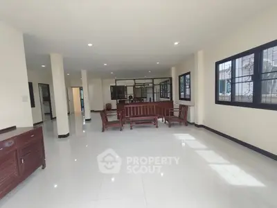 Spacious living room with elegant wooden furniture and large windows